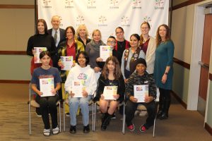 Group photo of students holding their peace poster award